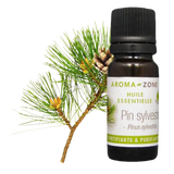 Botella de Aceite Esencial de Pino de Aroma Zone con ramita de pino al fondo